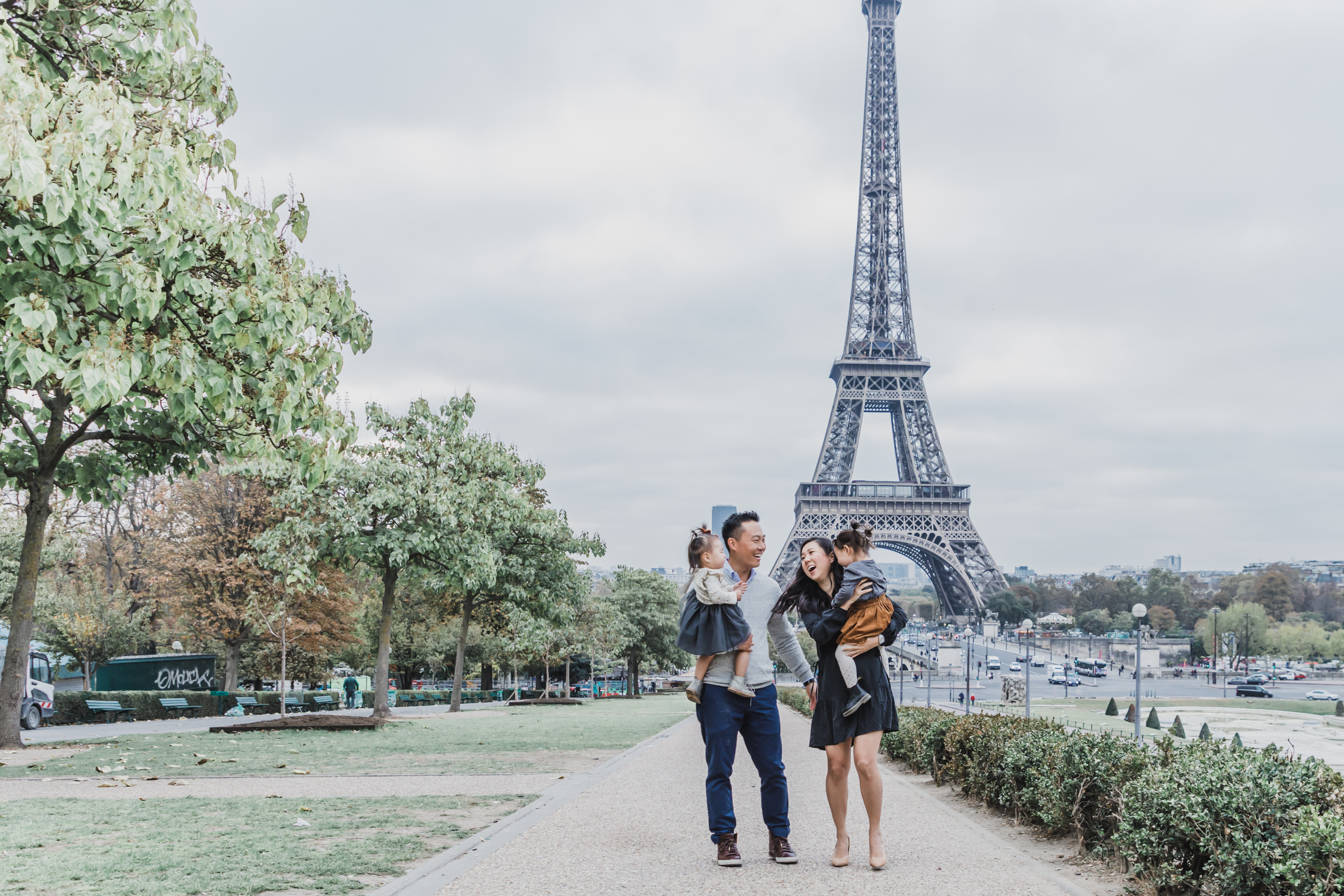 Family of four in front of the Eiffel Tower in Paris, France